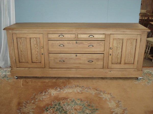 Pine dresser with drawers centre flanked by cupboards. 240cms. wide