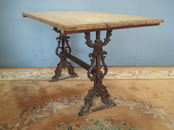 On decorative Cast Iron base. Vintage Pine Table.