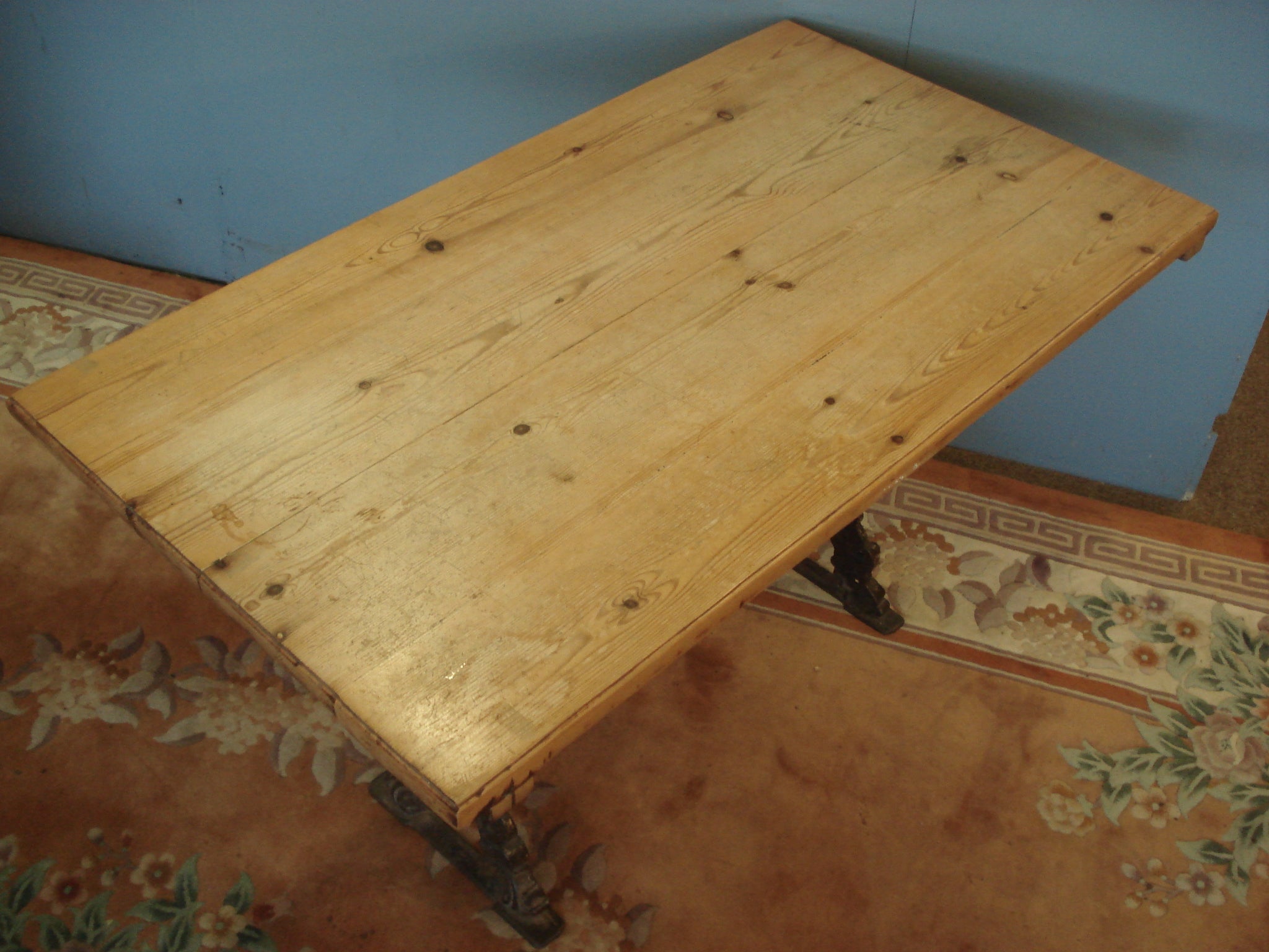 On decorative Cast Iron base. Vintage Pine Table.