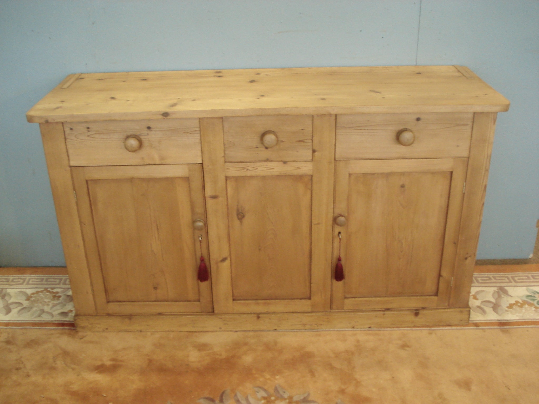 Three drawer, two door antique pine dresser base. The plate rack is available.
