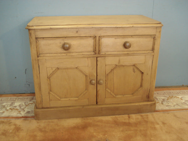 Octagonal panelled doors to this 19th century pine dresser base