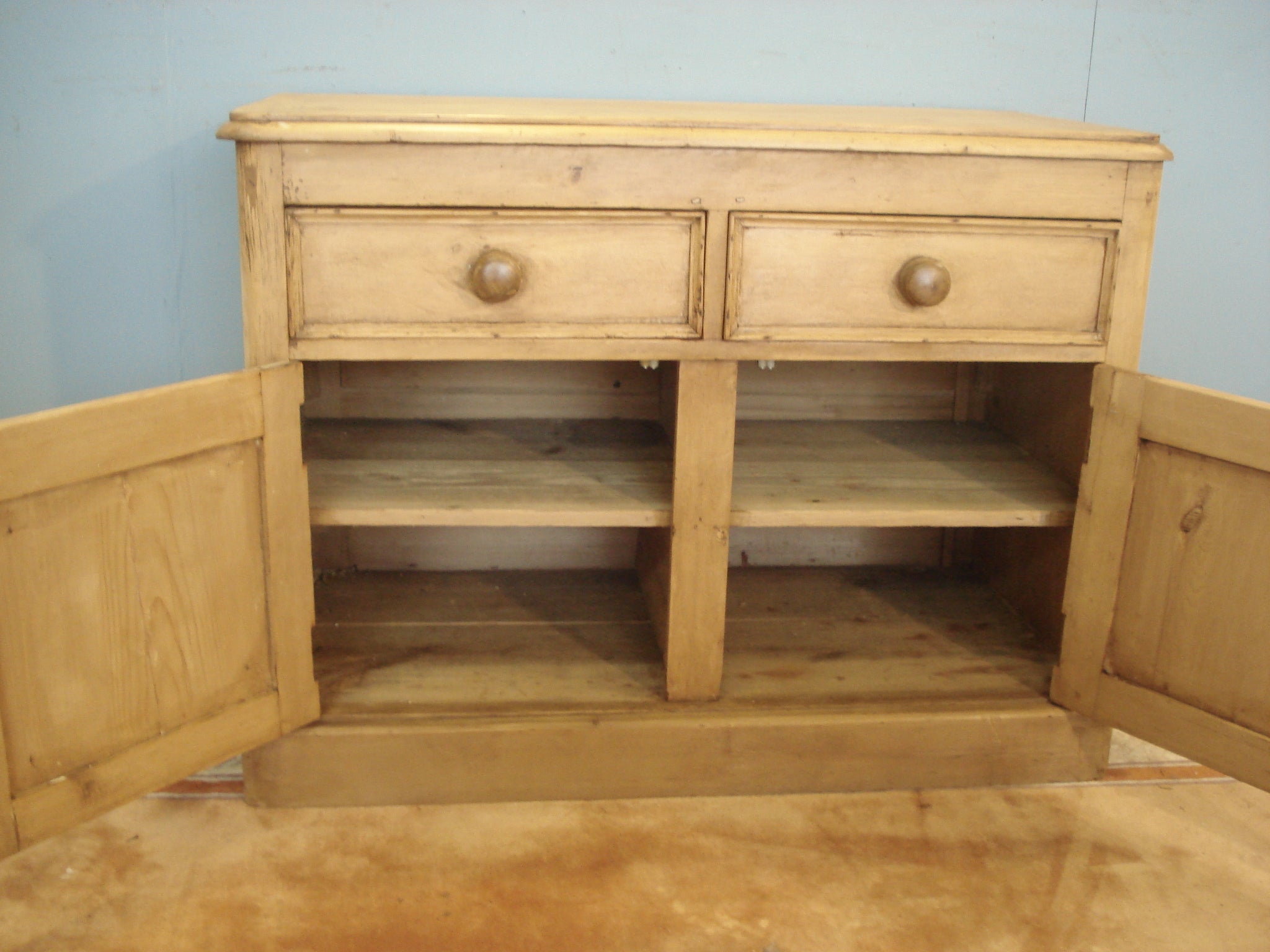 Octagonal panelled doors to this 19th century pine dresser base