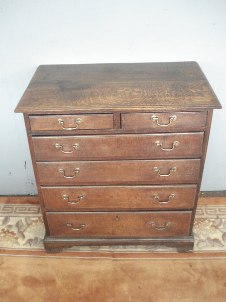 Narrow late C18th small six drawer oak chest. In its original finish.