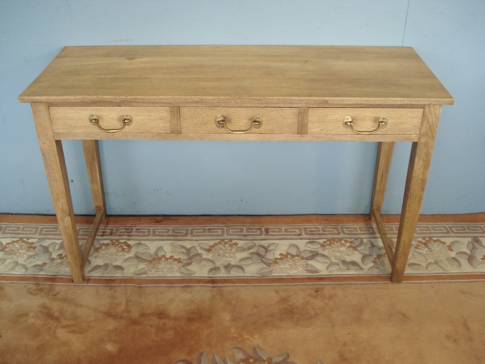 Three drawer blonde oak server / writing table