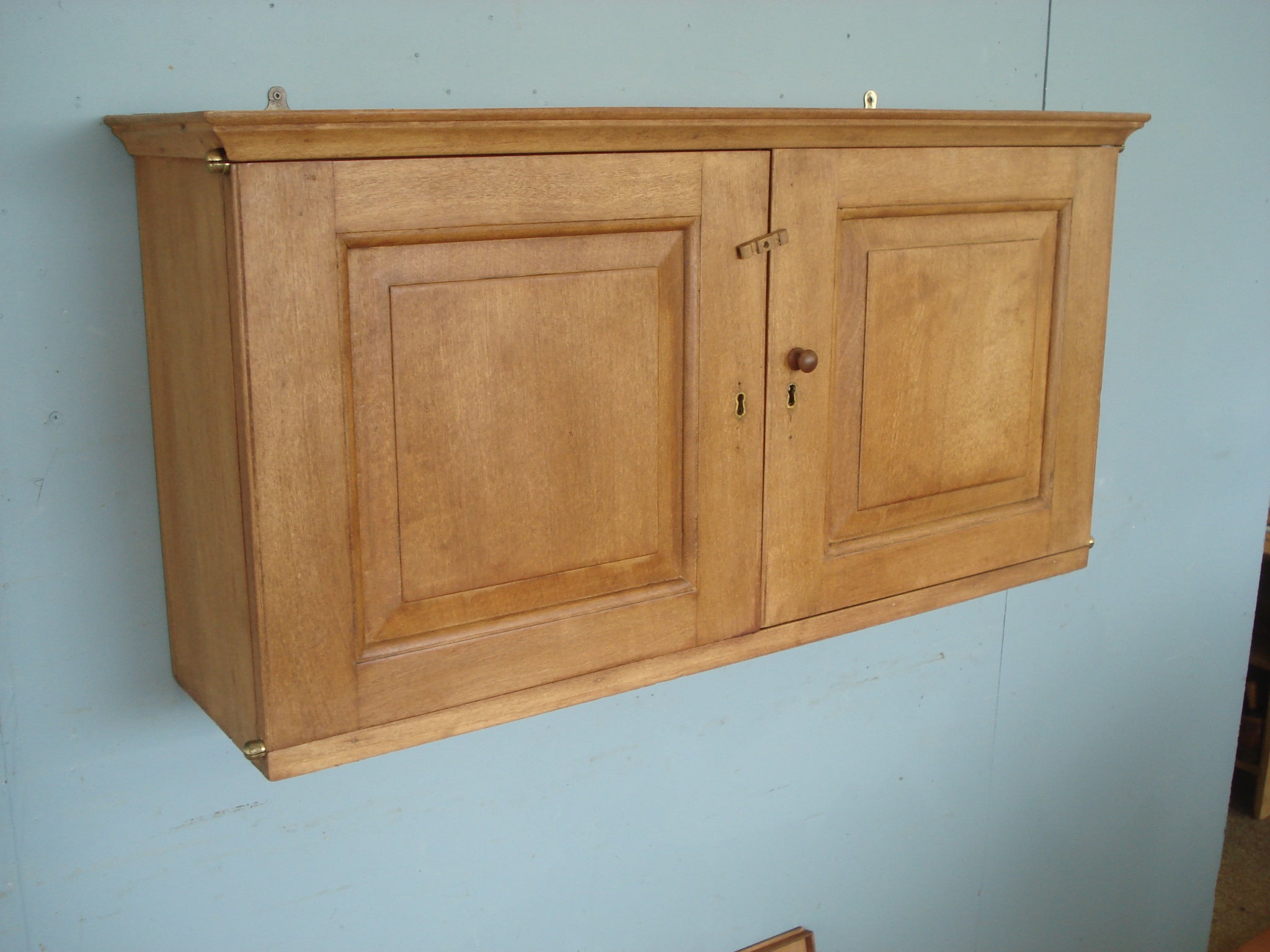 Wall cabinet in blonde mahogany with specimen drawers and slide out shelves. Circa 1860