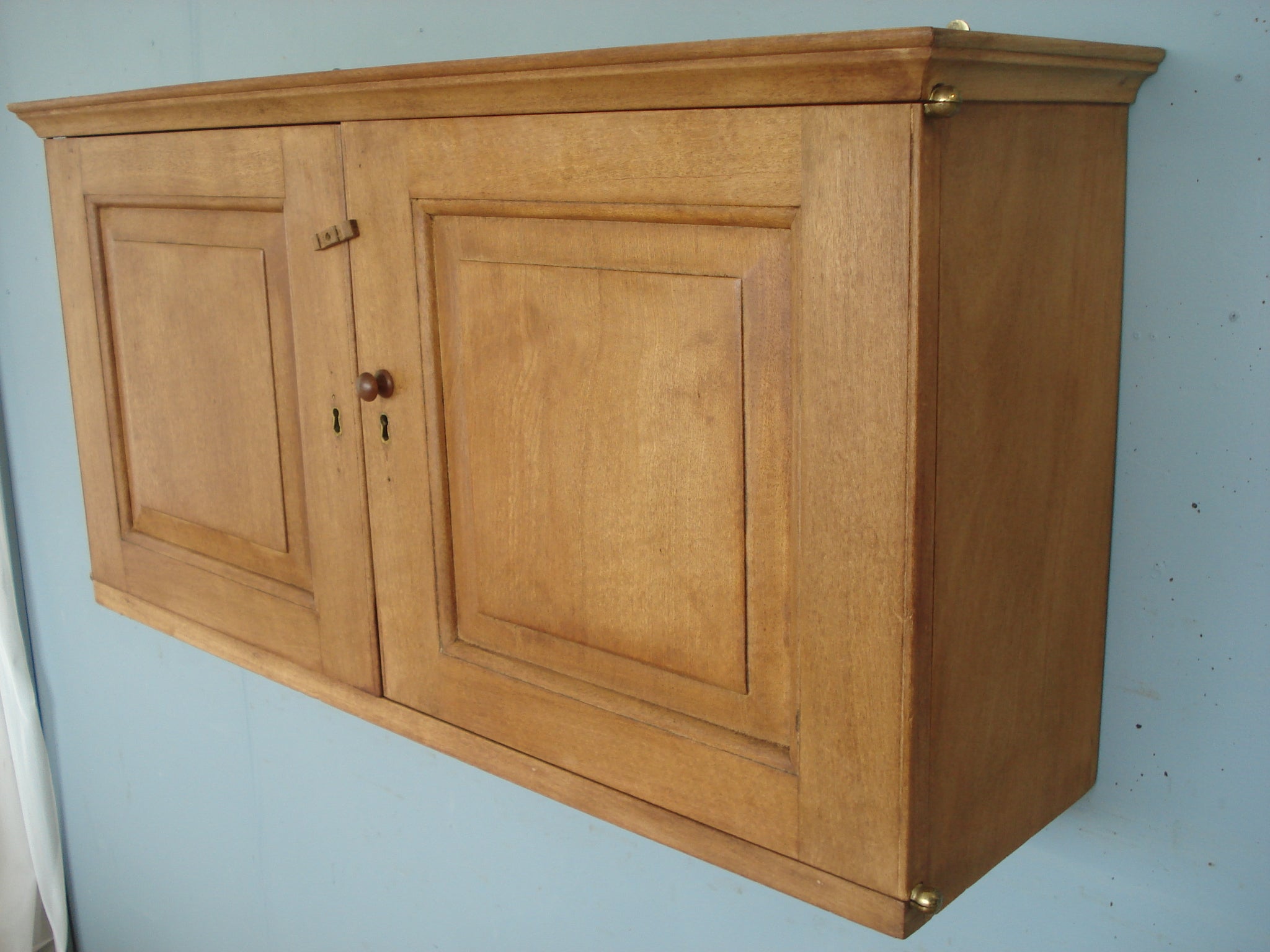 Wall cabinet in blonde mahogany with specimen drawers and slide out shelves. Circa 1860