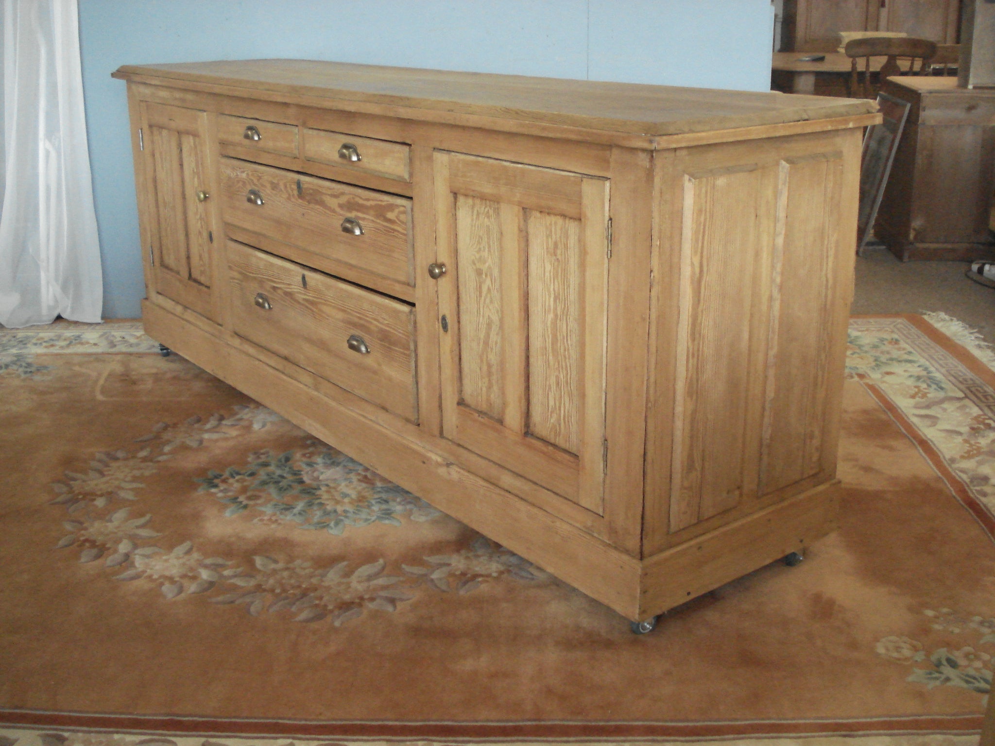 Pine dresser with drawers centre flanked by cupboards. 240cms. wide